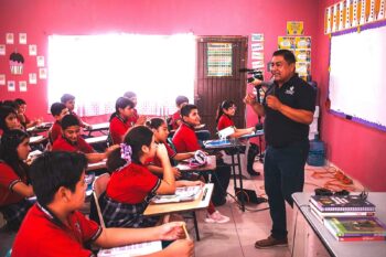 River Ministry missionary Pedro Muñoz speaks to a classroom of engaged elementary students during the children's program portion of the Family Health Parenting Program