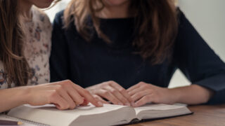 Christian worship and praise. Happy friends reading the bible together.